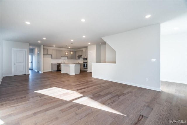 unfurnished living room with hardwood / wood-style flooring