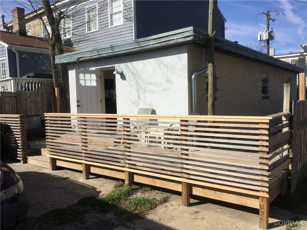 view of property exterior with a deck