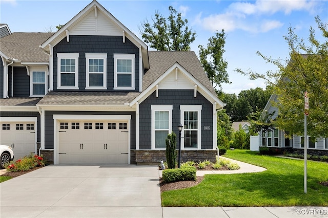 craftsman inspired home featuring a front yard and a garage