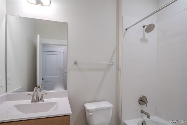 full bathroom with vanity, tiled shower / bath combo, and toilet