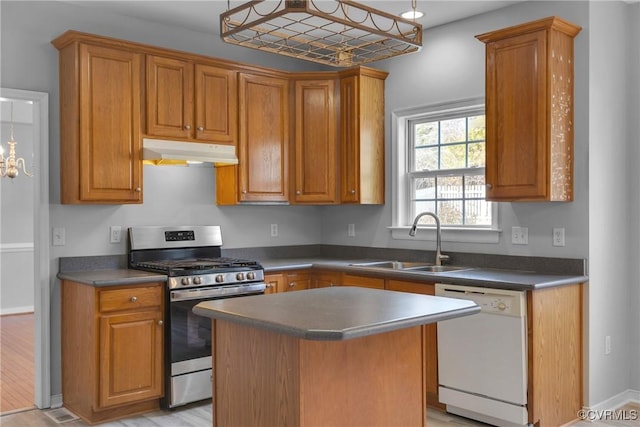 kitchen featuring sink, dishwasher, a center island, stainless steel gas range, and light hardwood / wood-style floors