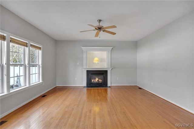 unfurnished living room featuring ceiling fan and light hardwood / wood-style floors