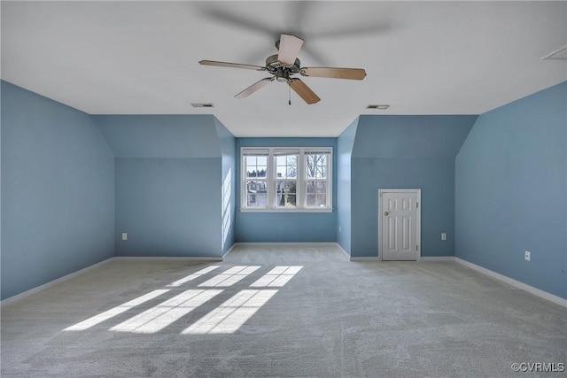 bonus room featuring light colored carpet, vaulted ceiling, and ceiling fan