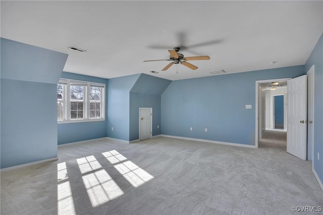 bonus room featuring ceiling fan, light carpet, and vaulted ceiling