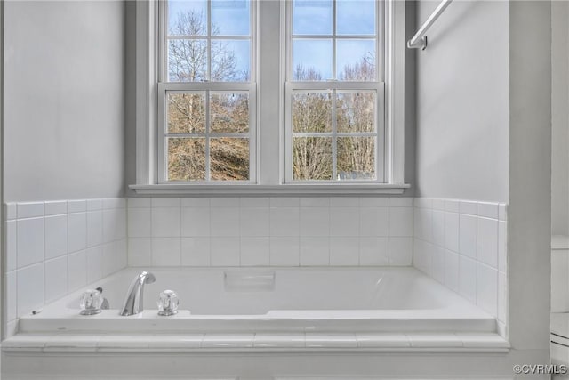 bathroom with tiled tub