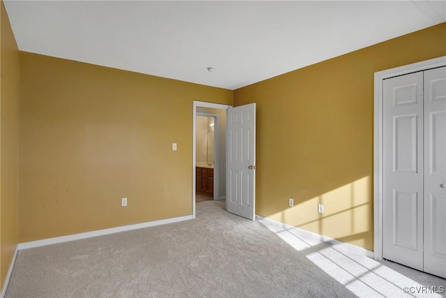 unfurnished bedroom with light carpet and a closet