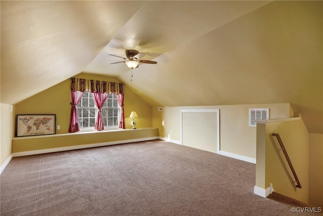 additional living space with carpet flooring, ceiling fan, and lofted ceiling