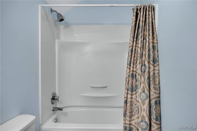 bathroom with toilet and shower / bathtub combination with curtain