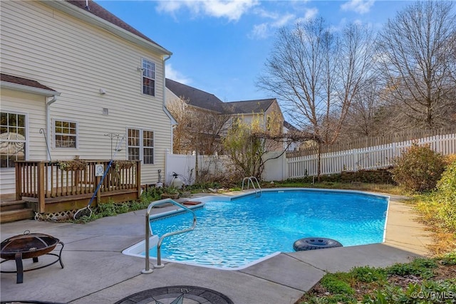 view of swimming pool with a fire pit and a deck