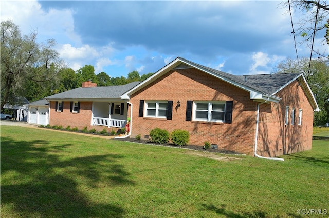 single story home with a garage, covered porch, and a front lawn