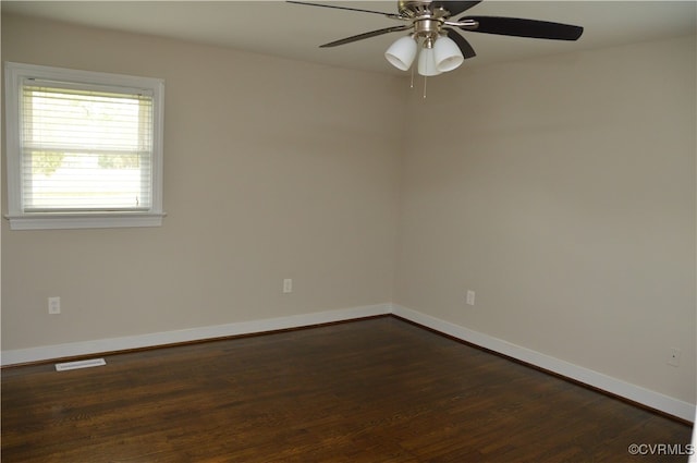 empty room with dark hardwood / wood-style floors and ceiling fan