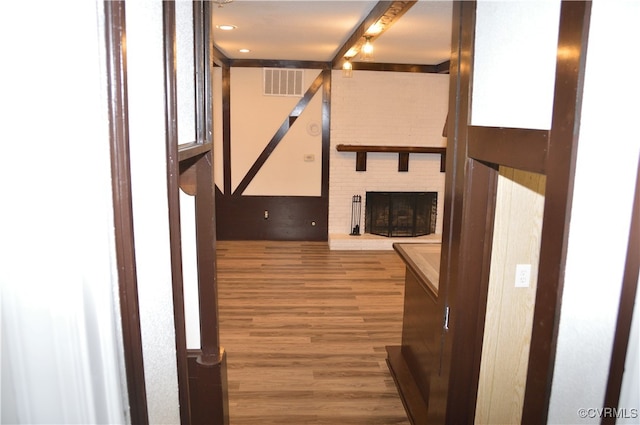 unfurnished living room featuring a fireplace and wood-type flooring