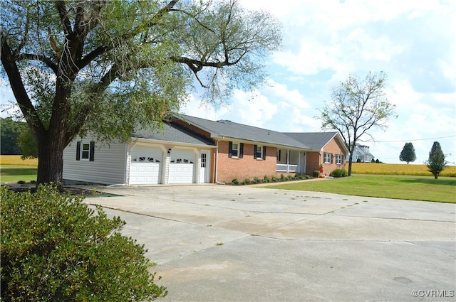 ranch-style home featuring a garage and a front yard