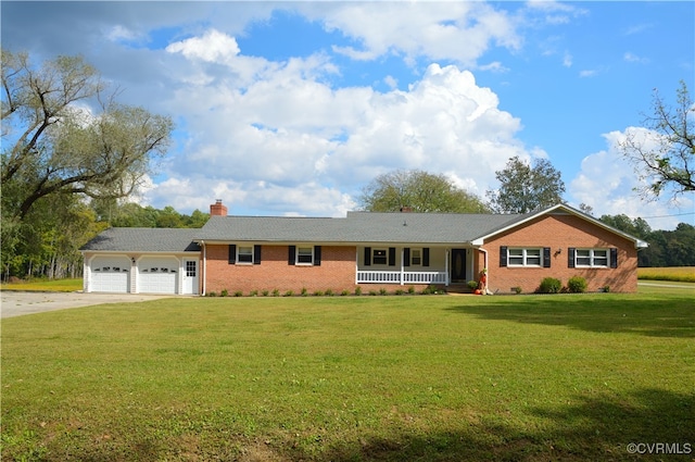 ranch-style house featuring covered porch, a garage, and a front lawn