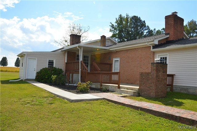 rear view of property with a lawn