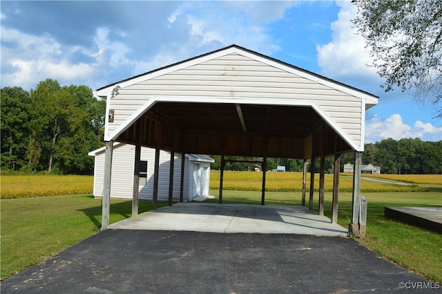 view of home's community with a lawn and an outdoor structure