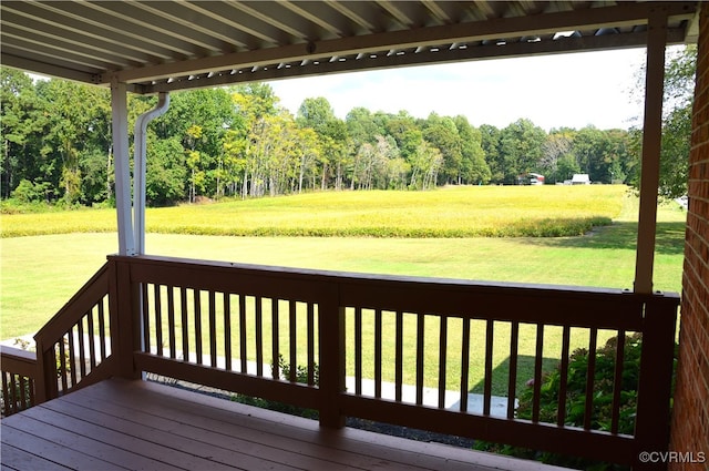 wooden deck featuring a lawn