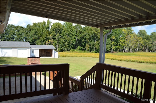 deck featuring a lawn and an outdoor structure