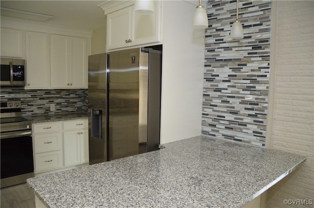 kitchen featuring backsplash, light stone countertops, decorative light fixtures, and appliances with stainless steel finishes