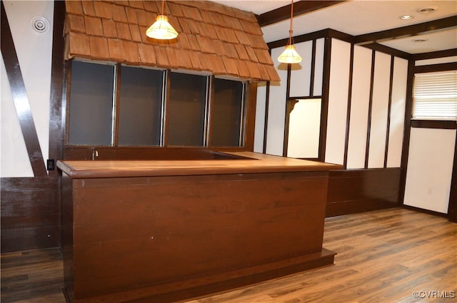 interior space with dark wood-type flooring and hanging light fixtures