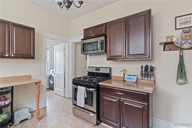 kitchen featuring washer / dryer, dark brown cabinetry, and appliances with stainless steel finishes