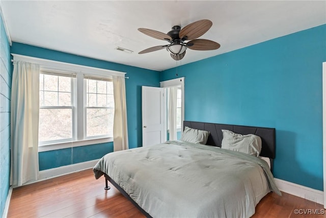 bedroom with ceiling fan and hardwood / wood-style flooring