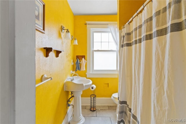 bathroom with tile patterned floors and toilet