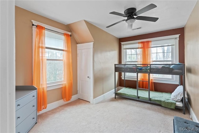 bedroom with light carpet, multiple windows, and ceiling fan