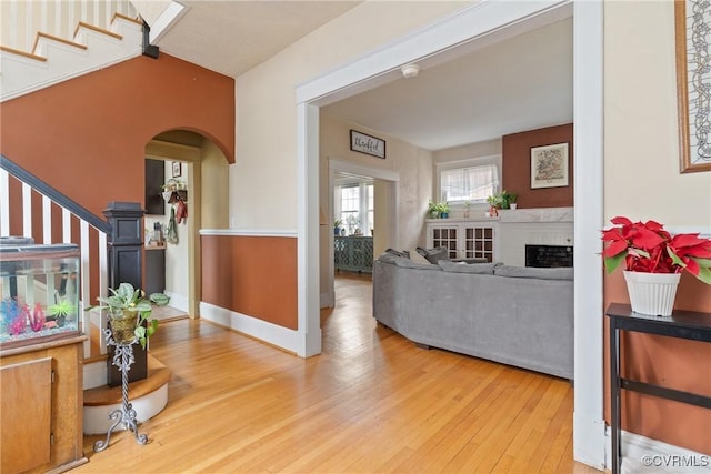 living room with a fireplace and wood-type flooring