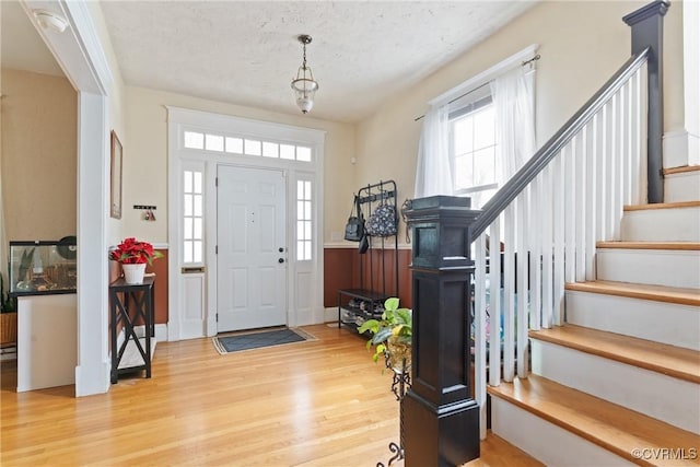 foyer featuring hardwood / wood-style floors and a textured ceiling