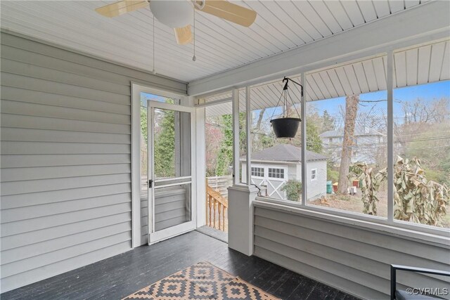 unfurnished sunroom with plenty of natural light and ceiling fan