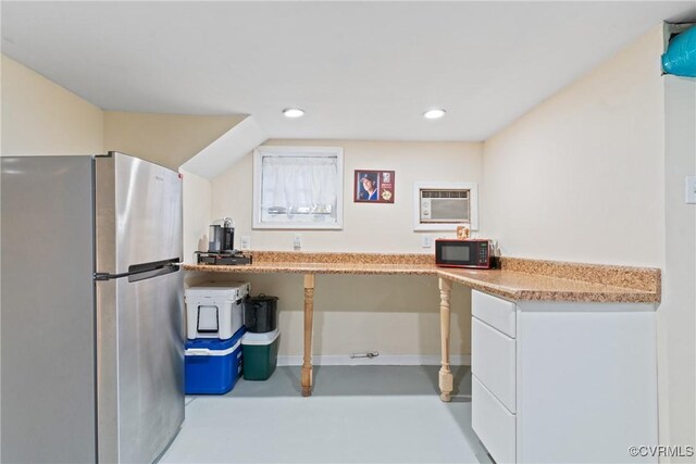 kitchen with stainless steel fridge and a wall mounted AC