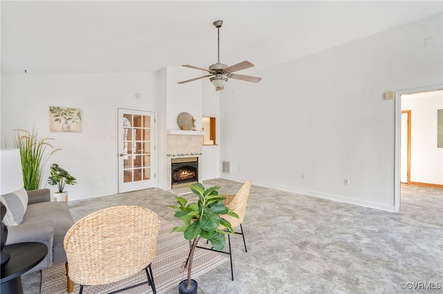 living room featuring ceiling fan, a large fireplace, and high vaulted ceiling