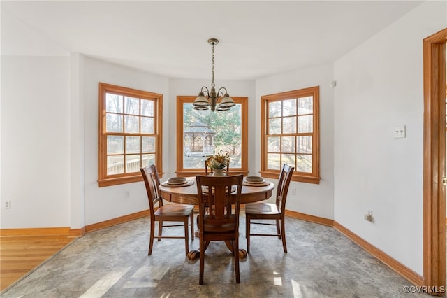 dining room featuring plenty of natural light, dark hardwood / wood-style flooring, and a chandelier