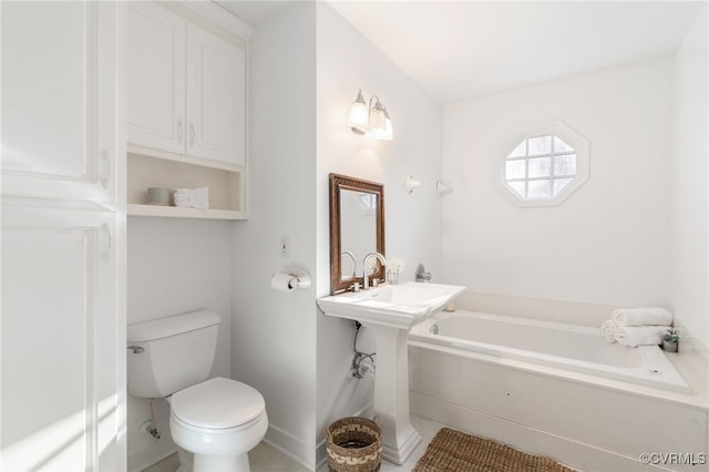 bathroom with tile patterned flooring, toilet, and a tub