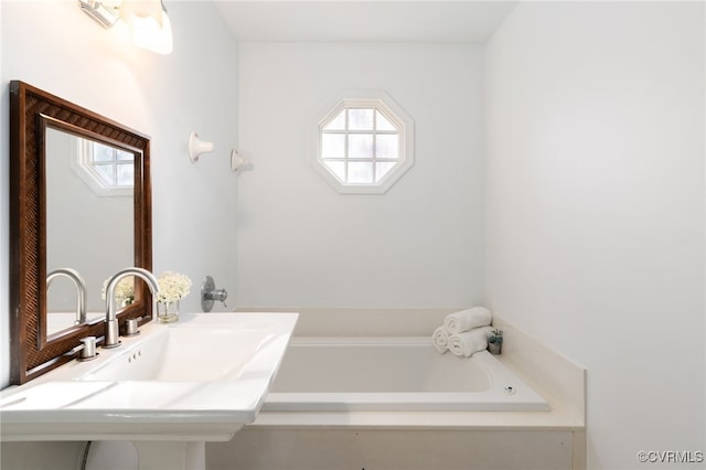 bathroom with sink and a washtub