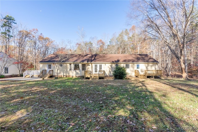 back of house with a yard and a wooden deck