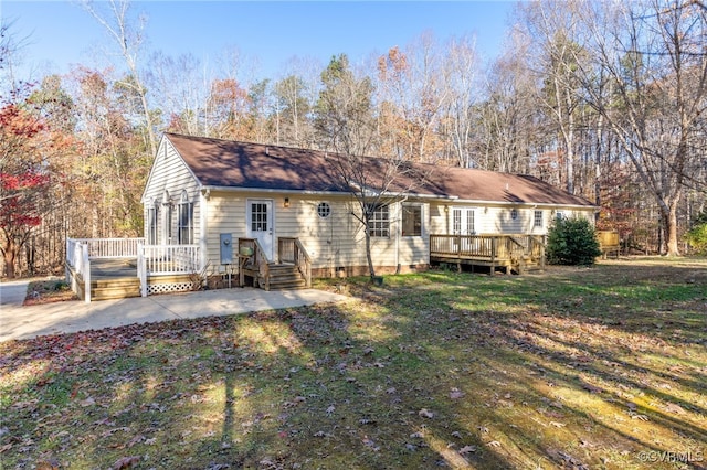 view of front of property with a patio, a deck, and a front lawn