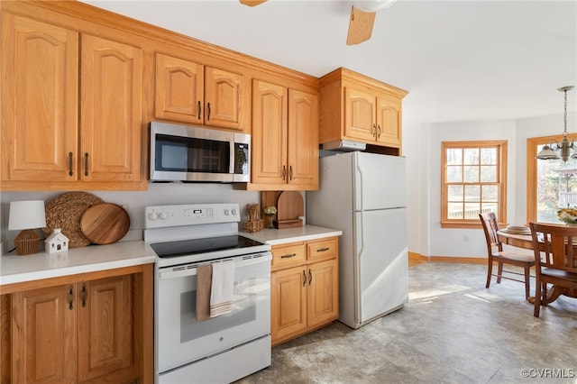 kitchen with ceiling fan with notable chandelier, white appliances, and decorative light fixtures