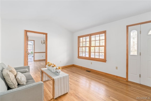 entryway featuring hardwood / wood-style floors, lofted ceiling, and a wealth of natural light