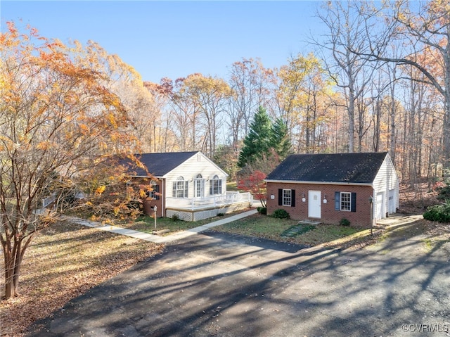 view of front facade featuring a garage and an outdoor structure