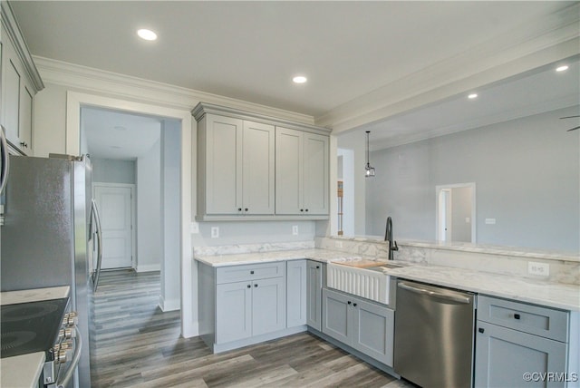 kitchen with gray cabinets, ornamental molding, wood-type flooring, and appliances with stainless steel finishes