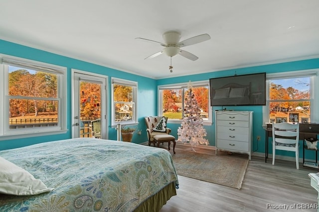 bedroom featuring access to outside, ceiling fan, crown molding, and light wood-type flooring