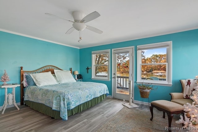 bedroom with hardwood / wood-style flooring, ceiling fan, access to exterior, and ornamental molding