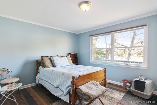 bedroom featuring dark hardwood / wood-style flooring and ornamental molding