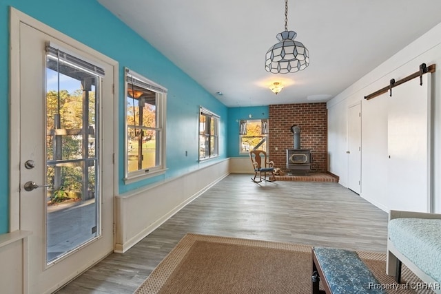 interior space with hardwood / wood-style floors and a wood stove