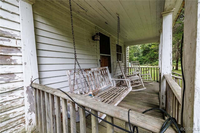 wooden terrace featuring covered porch