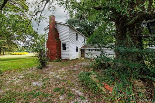 view of property exterior with a yard