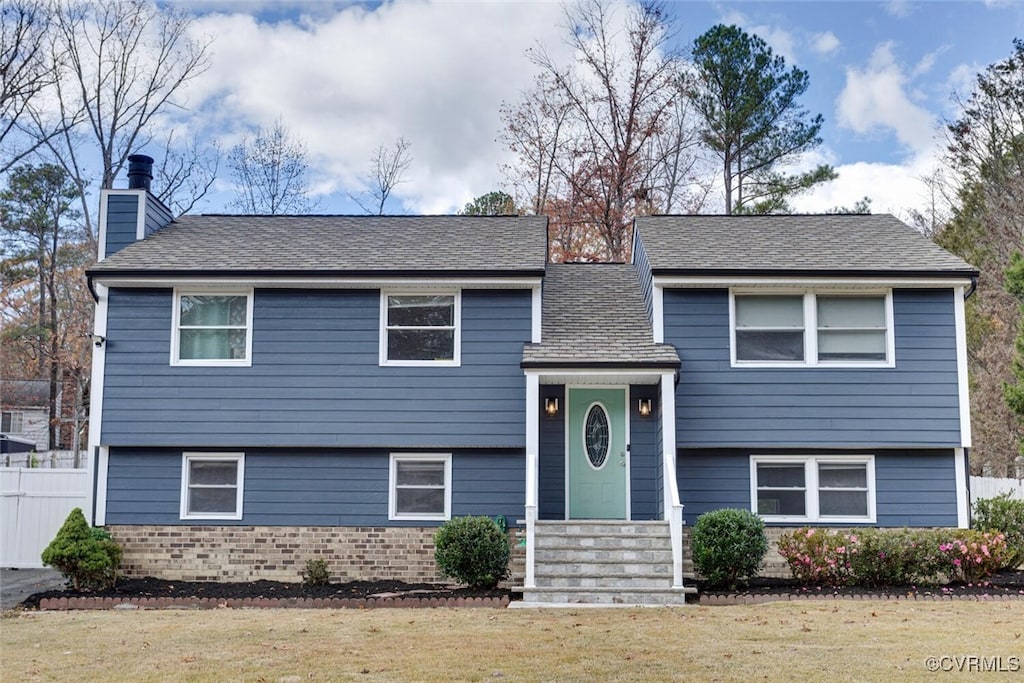 bi-level home with a front lawn