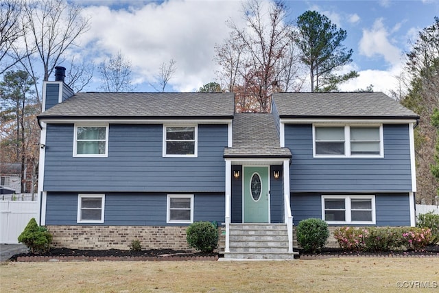 bi-level home with a front lawn